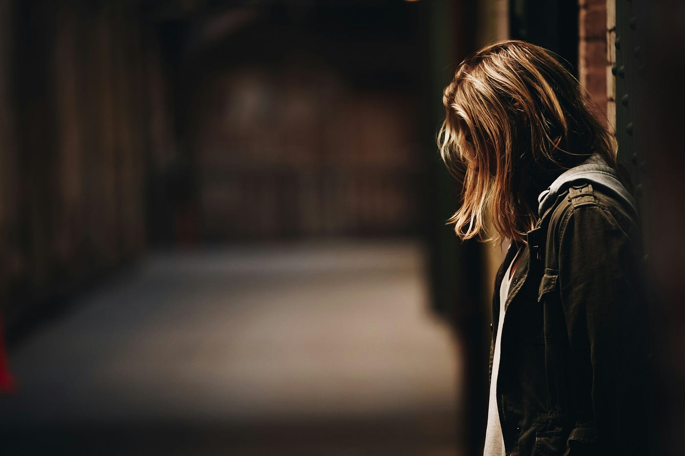 Young woman looking downward and sad