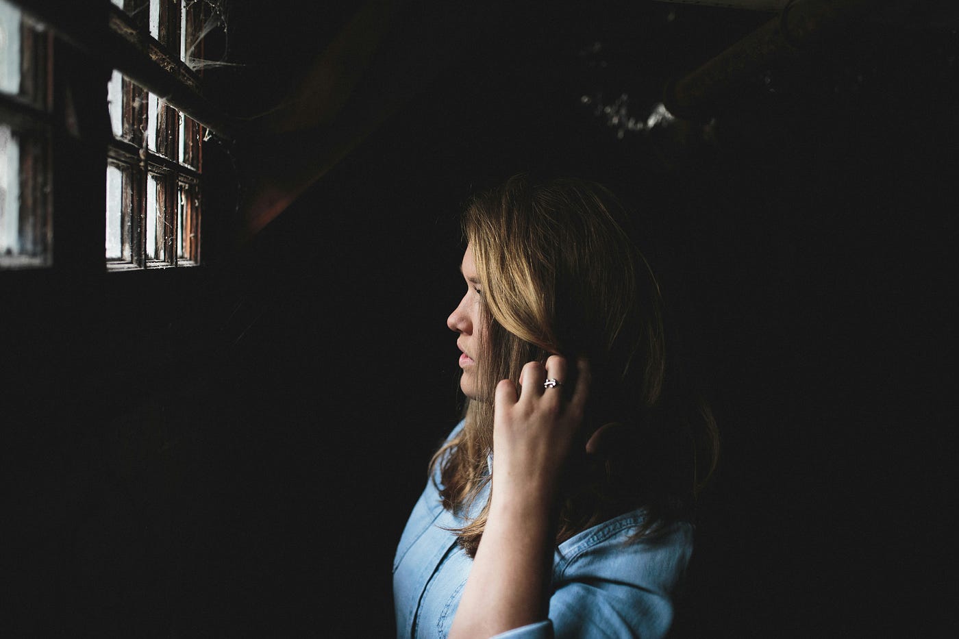 Woman looking through window